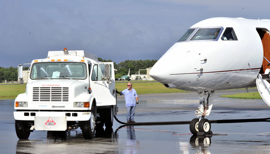 white truck fueling white plane