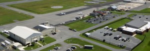 aerial view of airport with cars and hangars and planes